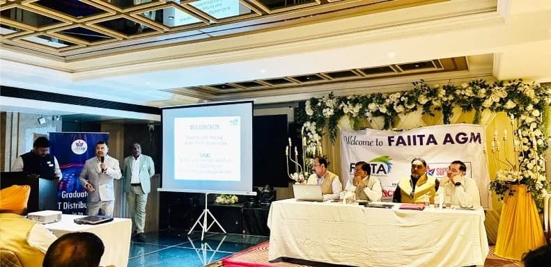 Wide view of the AGM session with the “Welcome to FAIITA AGM” backdrop and presentation screen.