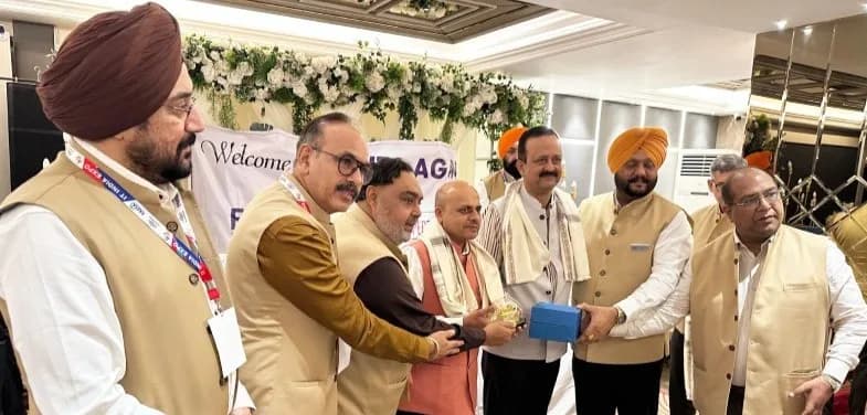 Another felicitation moment with a blue box and memento being presented.