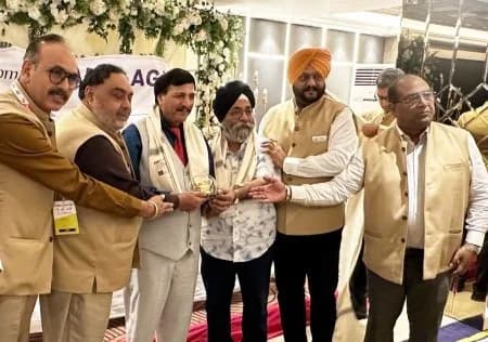 Group felicitation of a member with a trophy during the AGM ceremony.